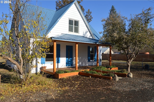 705 Couch Ave, Wallowa, OR 97885 - view of front of house featuring metal roof, a garden, and a porch