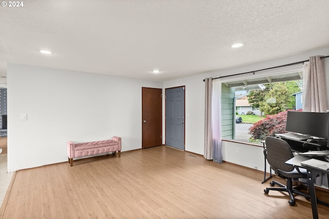 office featuring light hardwood / wood-style flooring and a textured ceiling