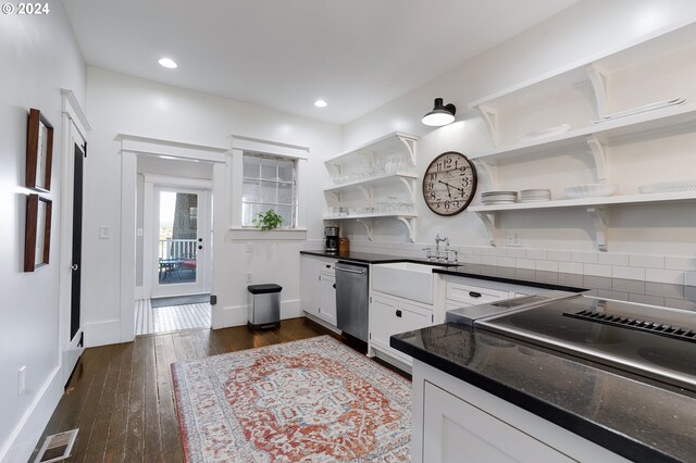 kitchen with white cabinets, dark countertops, dark wood-style floors, open shelves, and stainless steel dishwasher