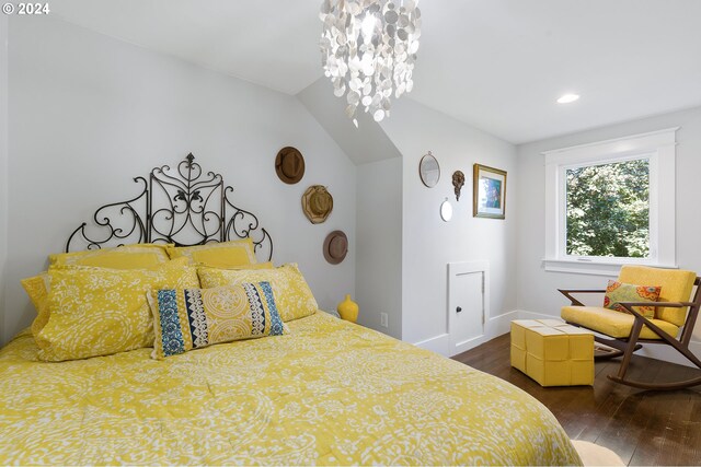 bedroom with a notable chandelier, baseboards, and dark wood-type flooring