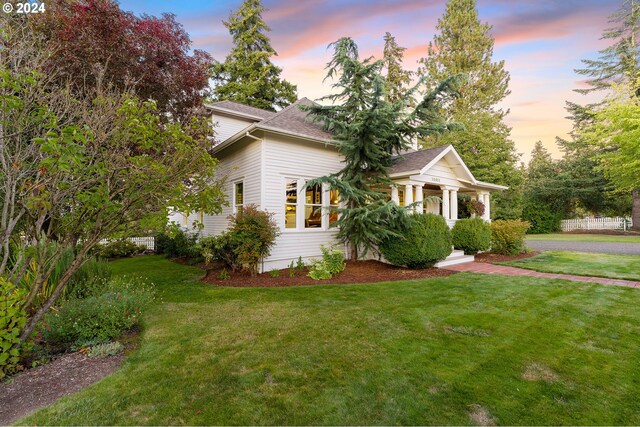 property exterior at dusk with a yard