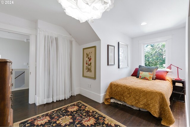 bedroom with baseboards and dark wood-style flooring