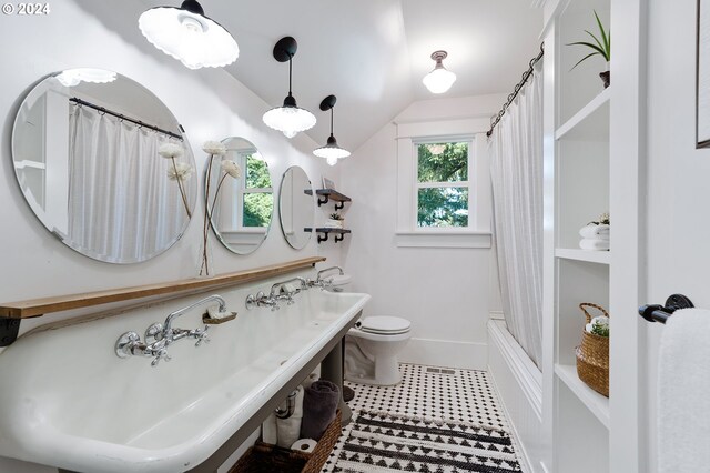 full bath with lofted ceiling, shower / bath combo, toilet, and baseboards