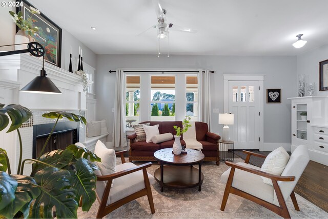 living area with a healthy amount of sunlight, a fireplace, and light wood finished floors