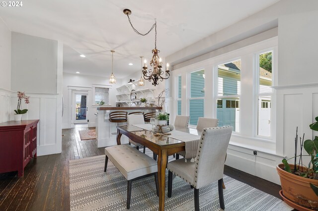 dining space featuring a wainscoted wall, a decorative wall, dark wood-style flooring, and recessed lighting