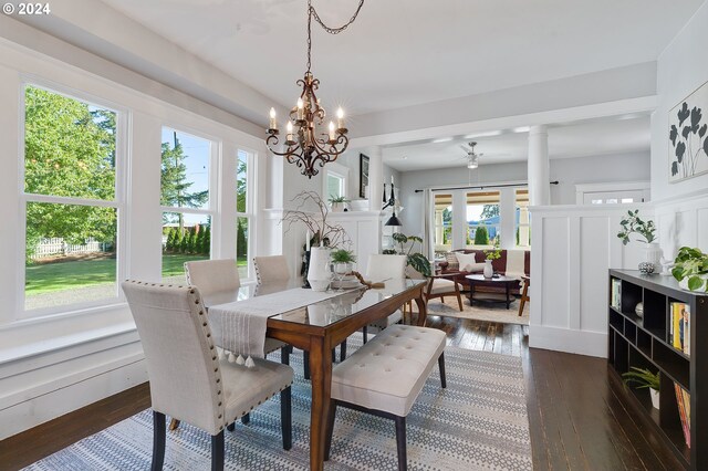 dining space featuring dark wood-type flooring and a notable chandelier