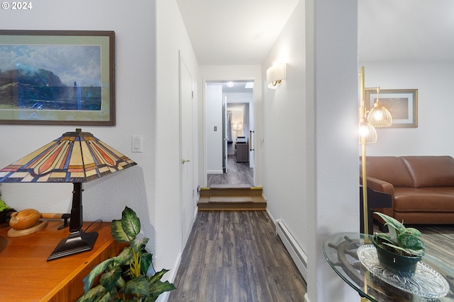 hall with dark hardwood / wood-style flooring and baseboard heating