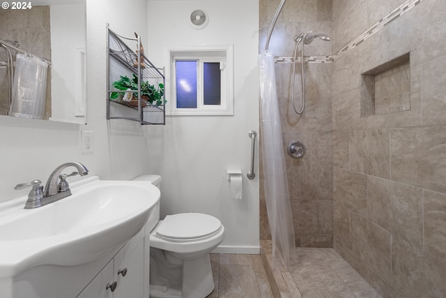 bathroom with vanity, toilet, and walk in shower