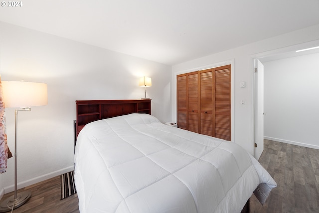 bedroom featuring a closet and dark hardwood / wood-style floors