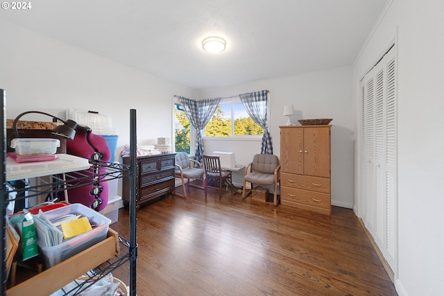 bedroom featuring crown molding, a closet, and dark wood-type flooring