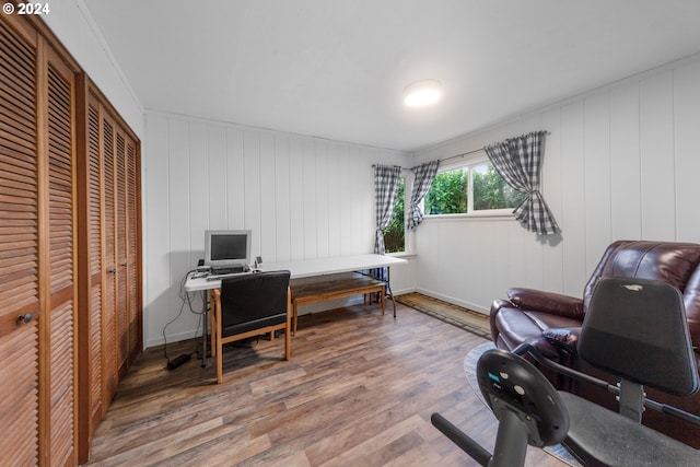 office with hardwood / wood-style flooring and wood walls