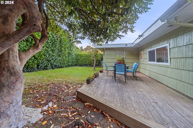 wooden terrace with a lawn