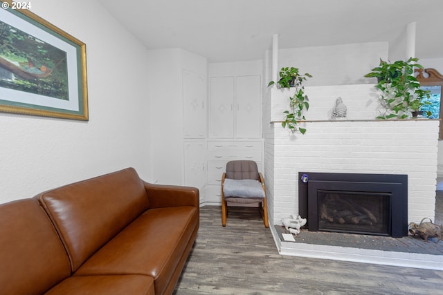 living room featuring hardwood / wood-style floors and a brick fireplace