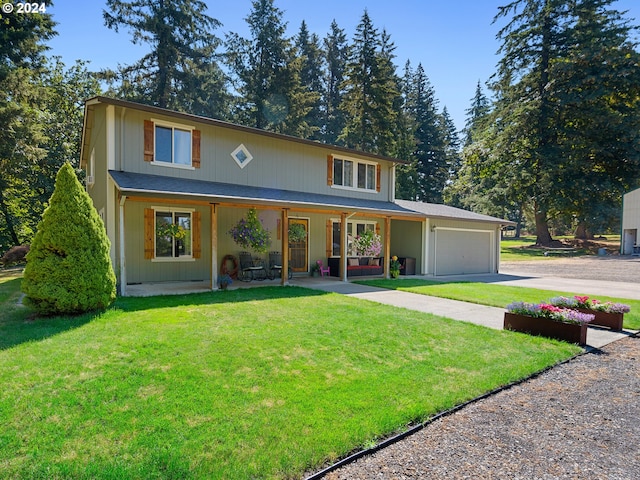 view of property featuring a garage, covered porch, and a front lawn