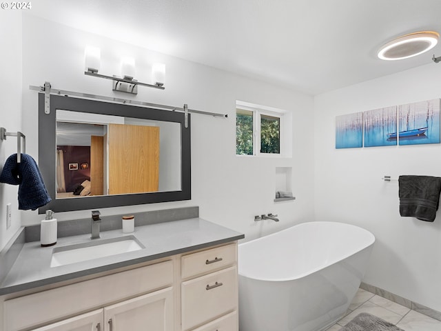 bathroom with tile patterned floors, vanity, and a bath