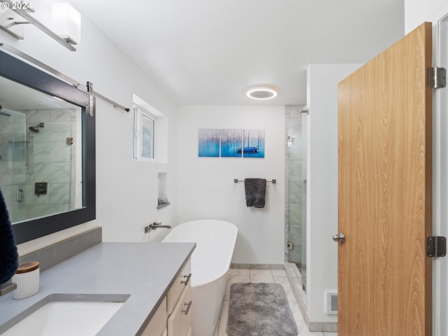 bathroom featuring shower with separate bathtub, vanity, and tile patterned floors