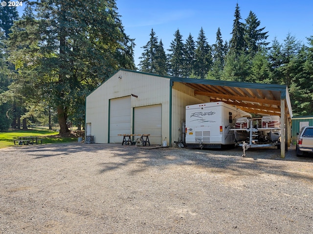 view of outdoor structure featuring a garage and a carport