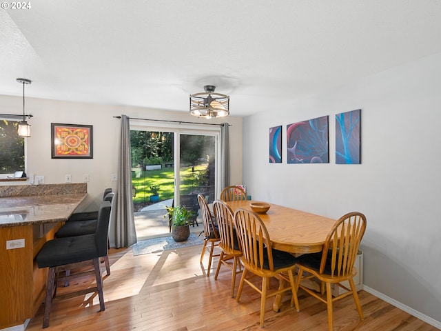 dining area with light wood-type flooring and a wealth of natural light