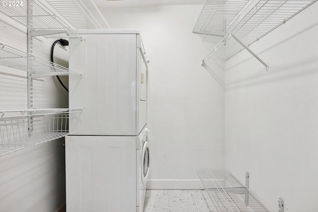 washroom featuring stacked washer / dryer