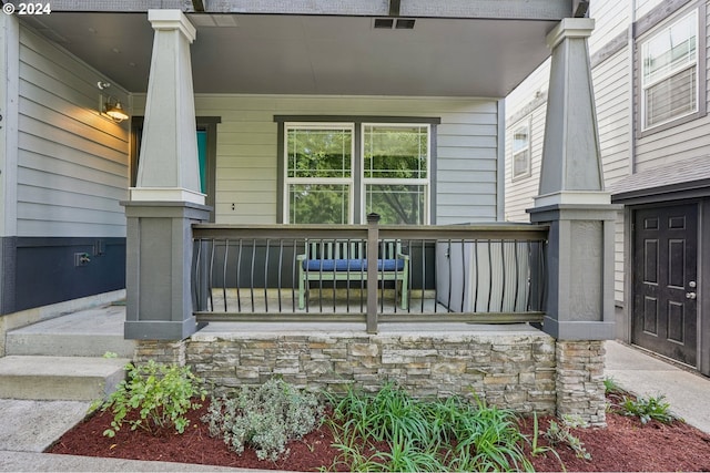 view of exterior entry with covered porch