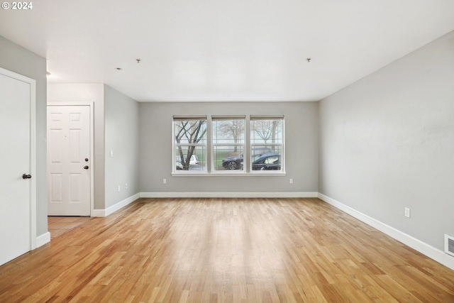 empty room with light hardwood / wood-style floors