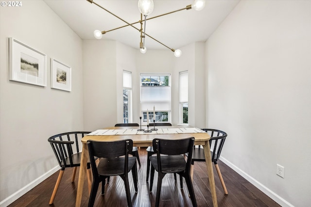 dining room with a chandelier and dark wood-type flooring