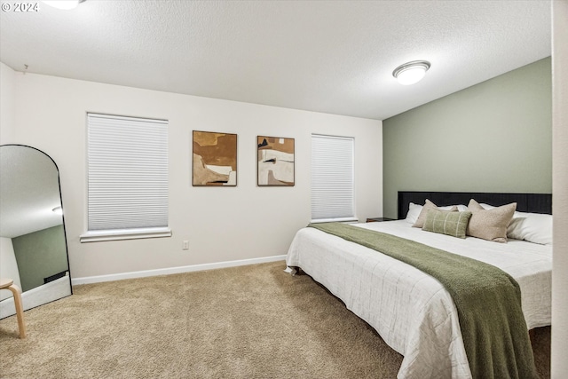 carpeted bedroom featuring a textured ceiling