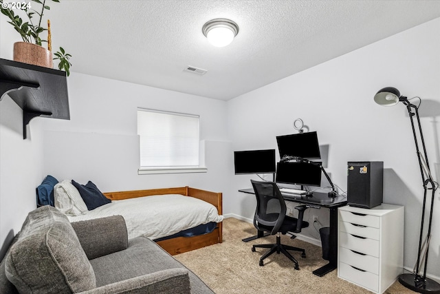 carpeted bedroom with a textured ceiling