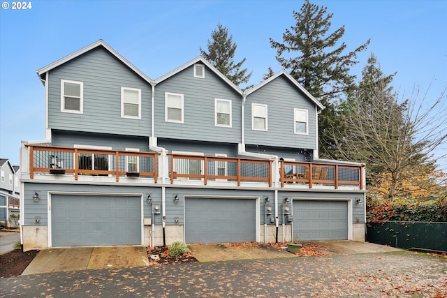 view of front facade featuring a balcony and a garage