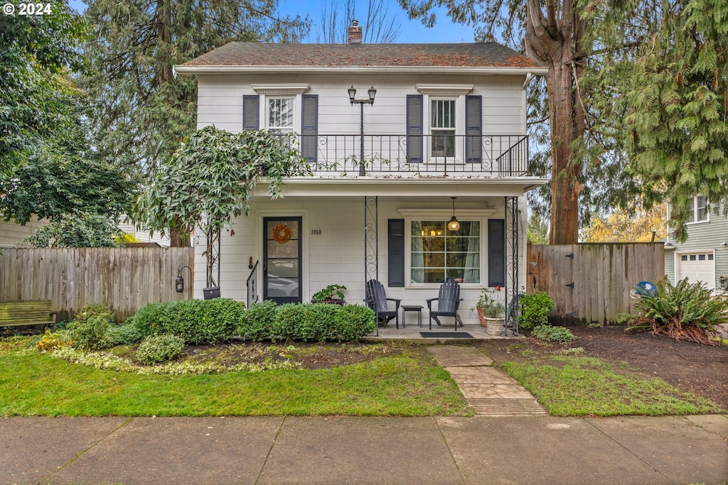 view of front facade featuring a balcony and a porch