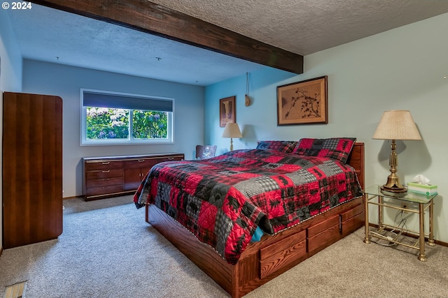 bedroom featuring beamed ceiling, a textured ceiling, and light colored carpet