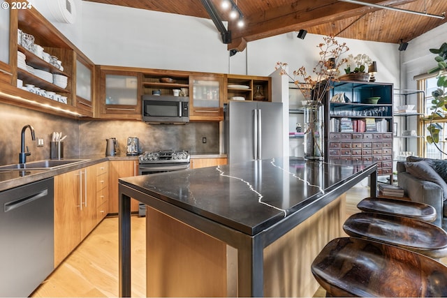 kitchen featuring appliances with stainless steel finishes, sink, light hardwood / wood-style flooring, wooden ceiling, and vaulted ceiling with beams