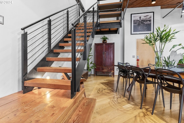 staircase with hardwood / wood-style flooring