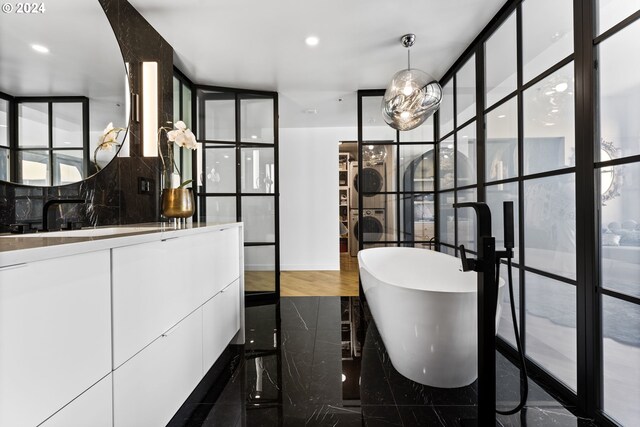 bathroom featuring wood-type flooring, sink, and a tub