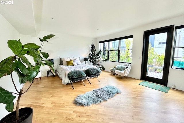 bedroom with access to exterior and light wood-type flooring