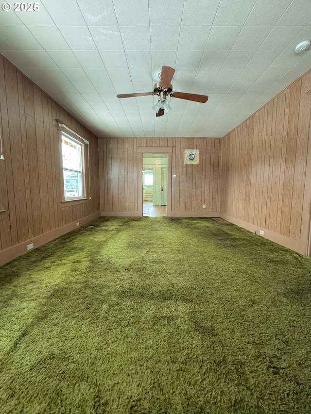 empty room with carpet floors and ceiling fan