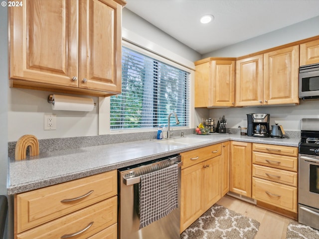 kitchen featuring light hardwood / wood-style flooring, stainless steel appliances, light brown cabinetry, and sink