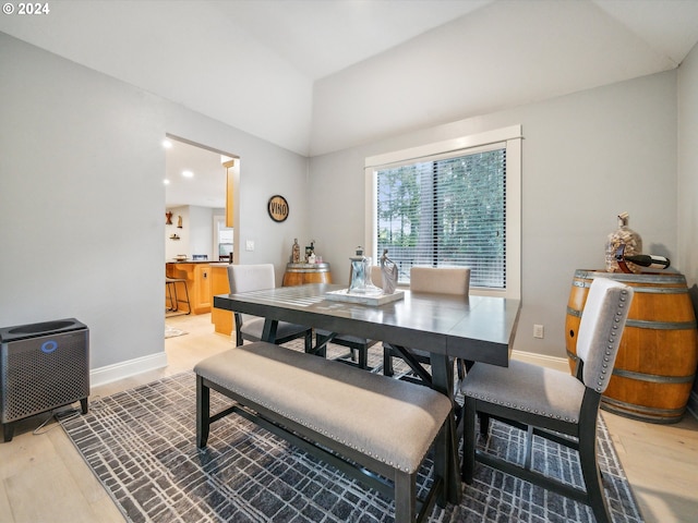 dining area featuring lofted ceiling and hardwood / wood-style flooring