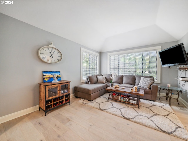 living room featuring lofted ceiling and light wood-type flooring