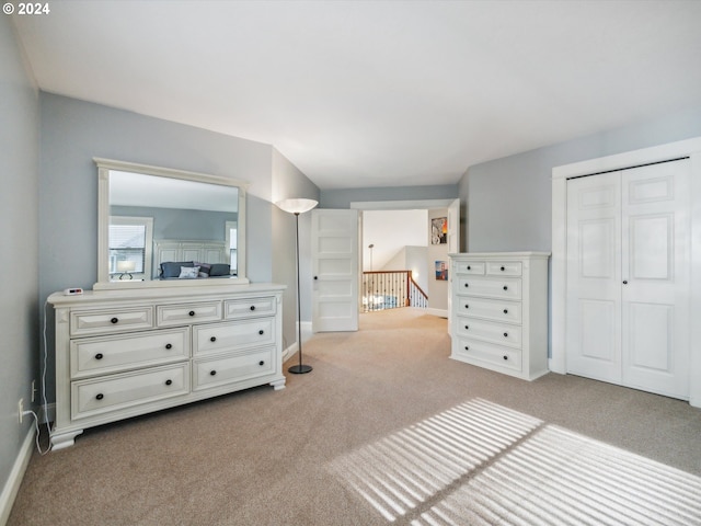 bedroom featuring light carpet and a closet