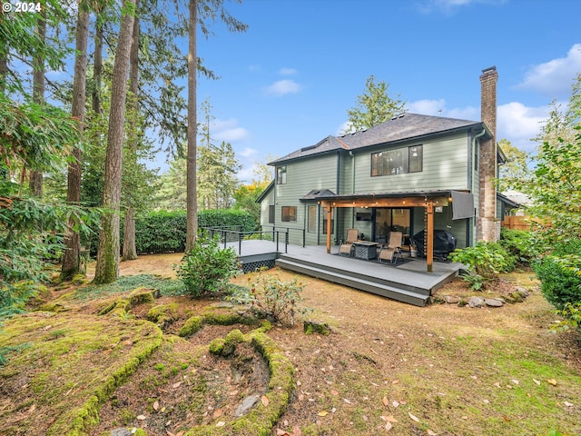 rear view of property with a wooden deck