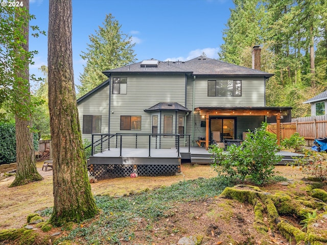 back of property with a wooden deck