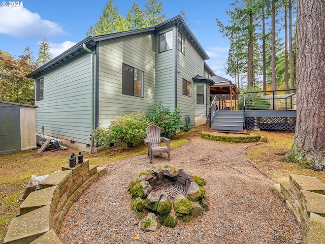 exterior space with a wooden deck and a storage unit