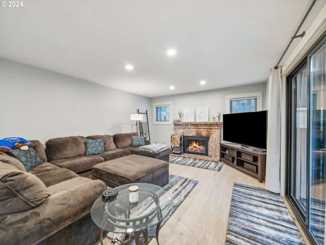 living room with light hardwood / wood-style flooring and a fireplace