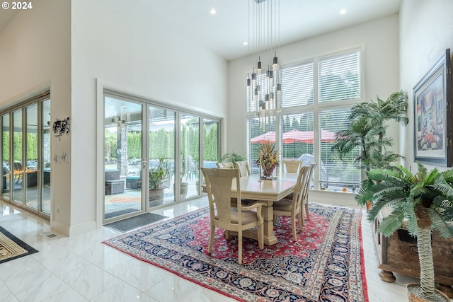 dining space featuring a high ceiling