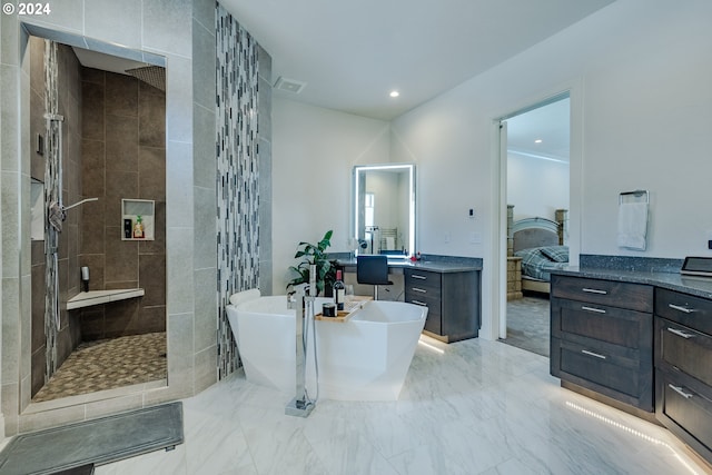 bathroom featuring vanity and shower with separate bathtub