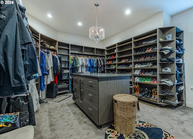 spacious closet with a notable chandelier and light carpet