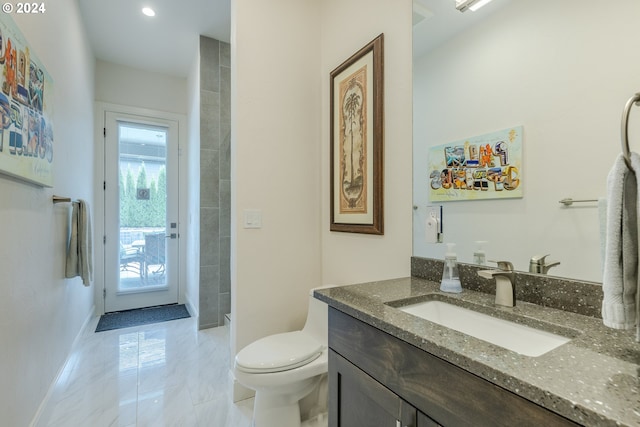 bathroom featuring vanity and toilet