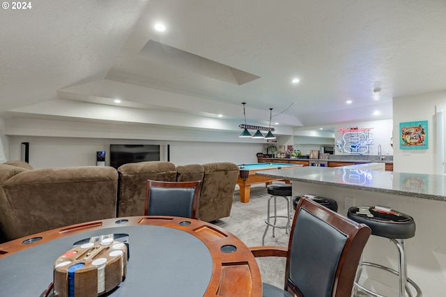 dining space featuring light carpet, a raised ceiling, pool table, and sink