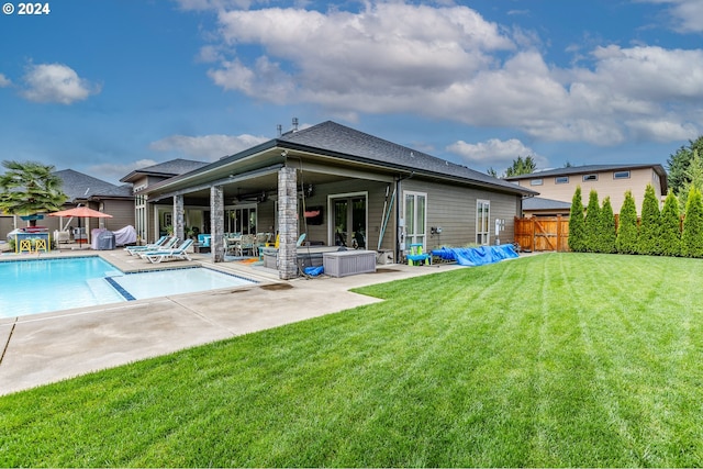 back of house featuring ceiling fan, a yard, and a patio